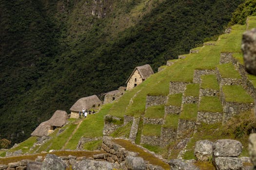 Explore the iconic stone terraces of Machu Picchu with lush green landscapes in Peru.