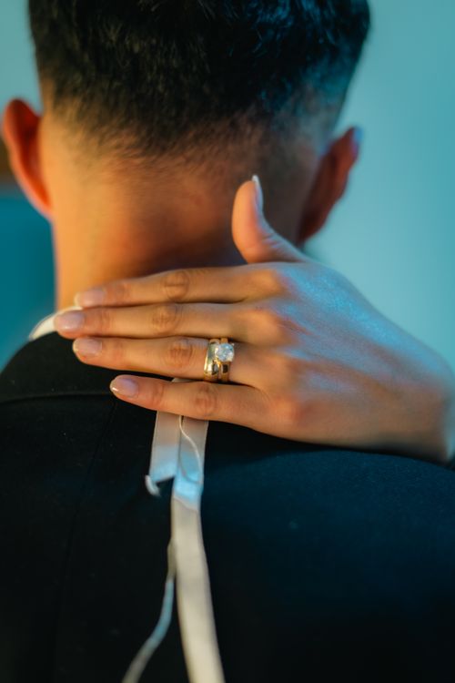 Free Close-up of an intimate embrace capturing a wedding ring, symbolizing love. Stock Photo