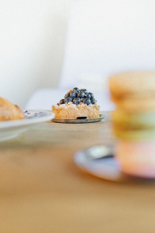 Free A blueberry tart elegantly placed on a wooden table, perfect for gourmet dessert lovers. Stock Photo
