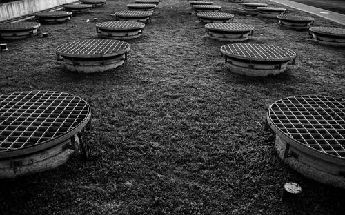Free Black and white photo of grid manhole covers on grass in Buenos Aires. Stock Photo