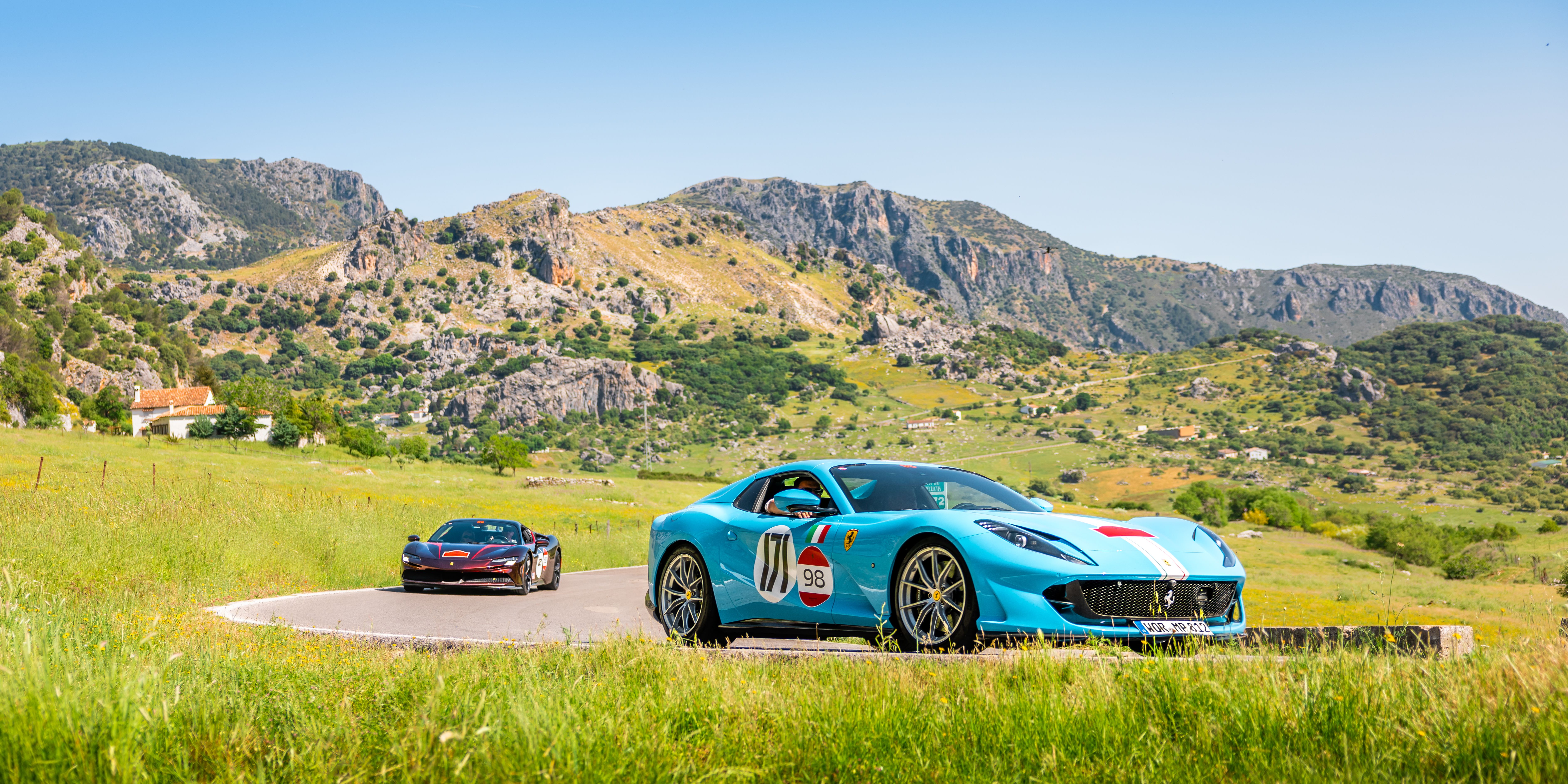 Sports Cars Racing Through Mountainous Landscape · Free Stock Photo