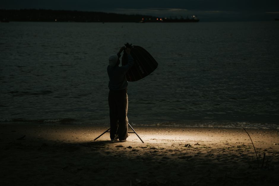 A photographer setting up a Sony camera on a tripod under a starry sky - how to composite night sky photos A photographer setting up a Sony camera on a tripod under a starry sky - how to composite night sky photos