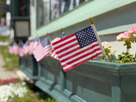 Line of American flags in flower boxes celebrating national holidays.
