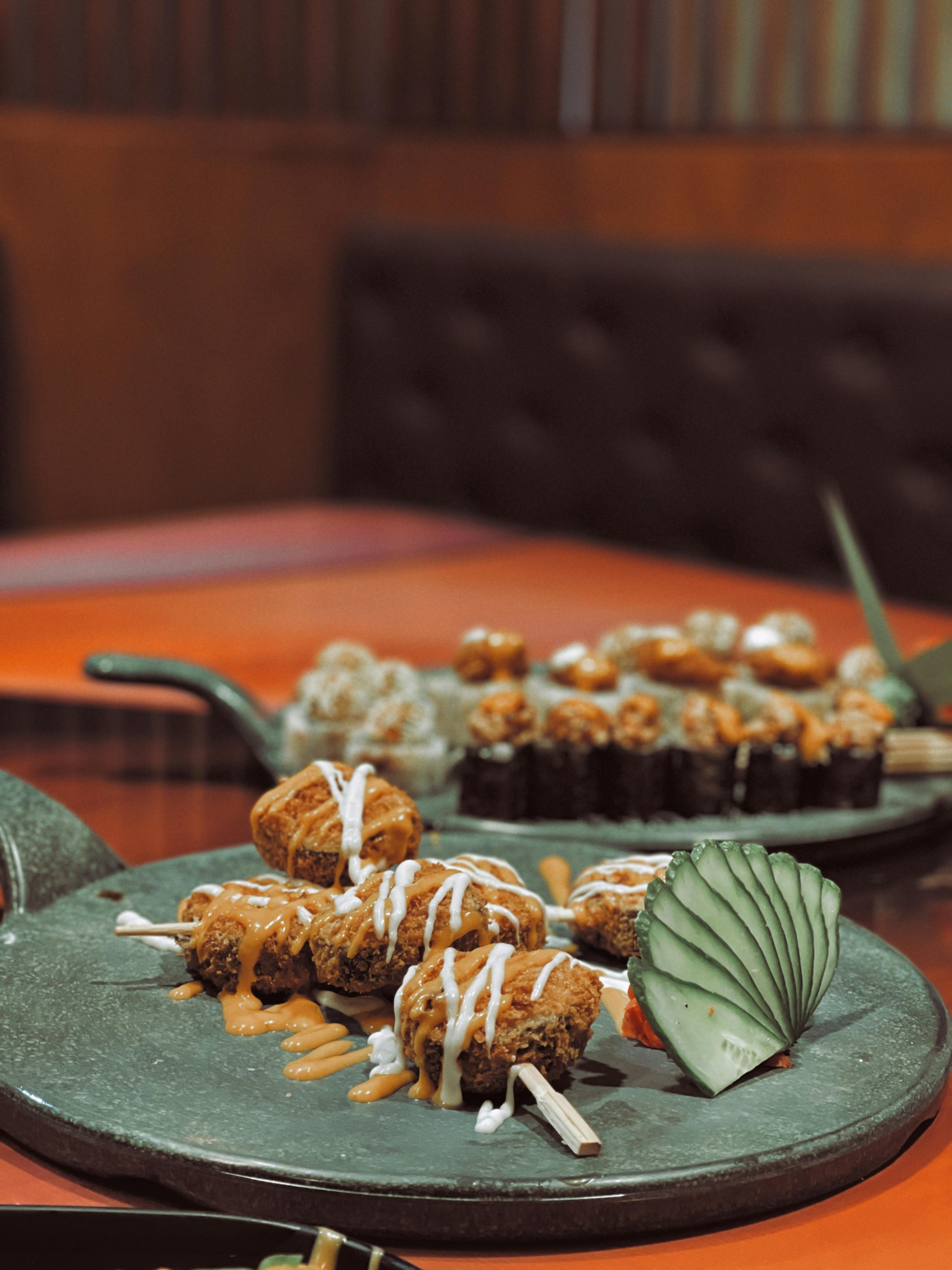 Appetizing sushi rolls elegantly presented on a stylish plate indoors.
