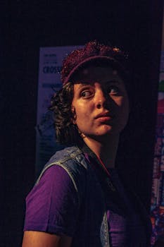 Artistic portrait of a woman in retro attire with warm lighting and vintage vibes.