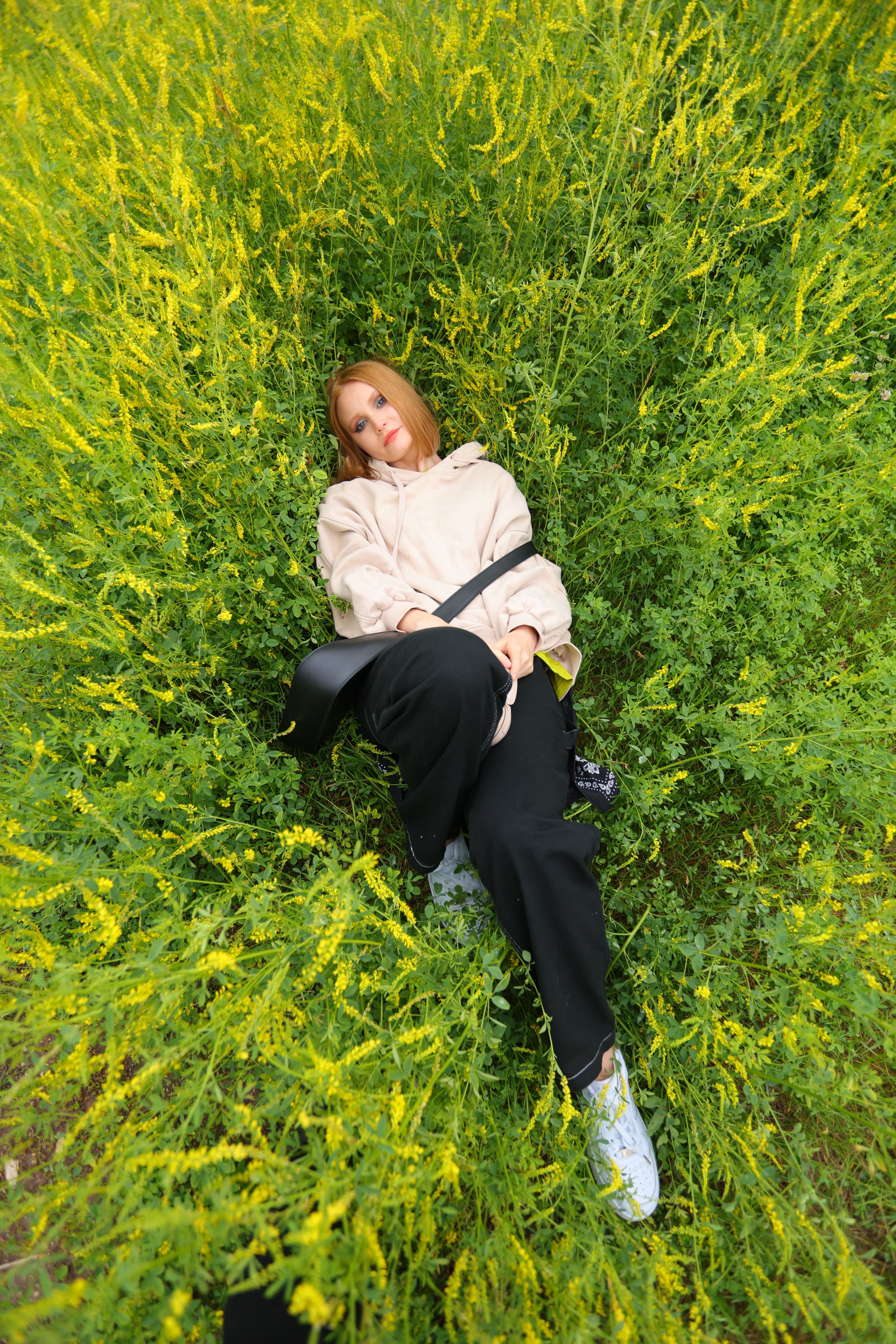 Woman Relaxing in Lush Greenery Surrounded by Nature · Free Stock Photo