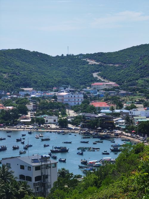 Free Picturesque harbor in Ninh Thuận, Vietnam, showcasing boats and lush hills. Stock Photo