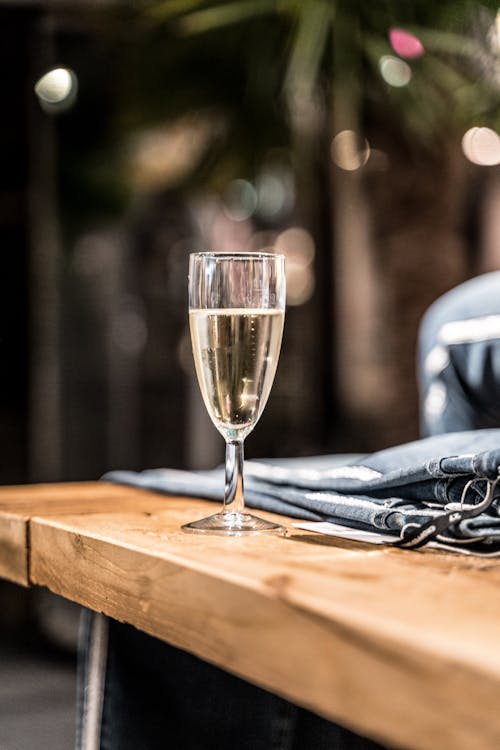 Free Champagne Glass on Brown Wooden Table Stock Photo