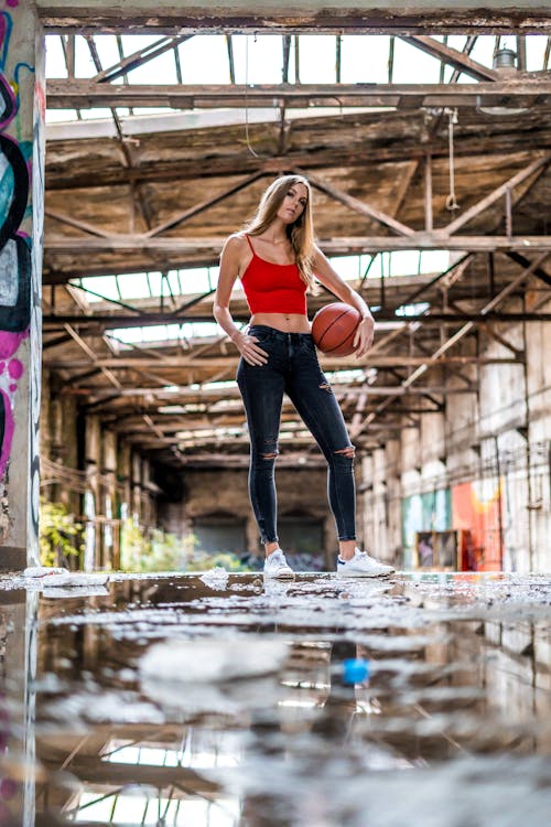 Woman in Red Tank Top Holding a Basketball