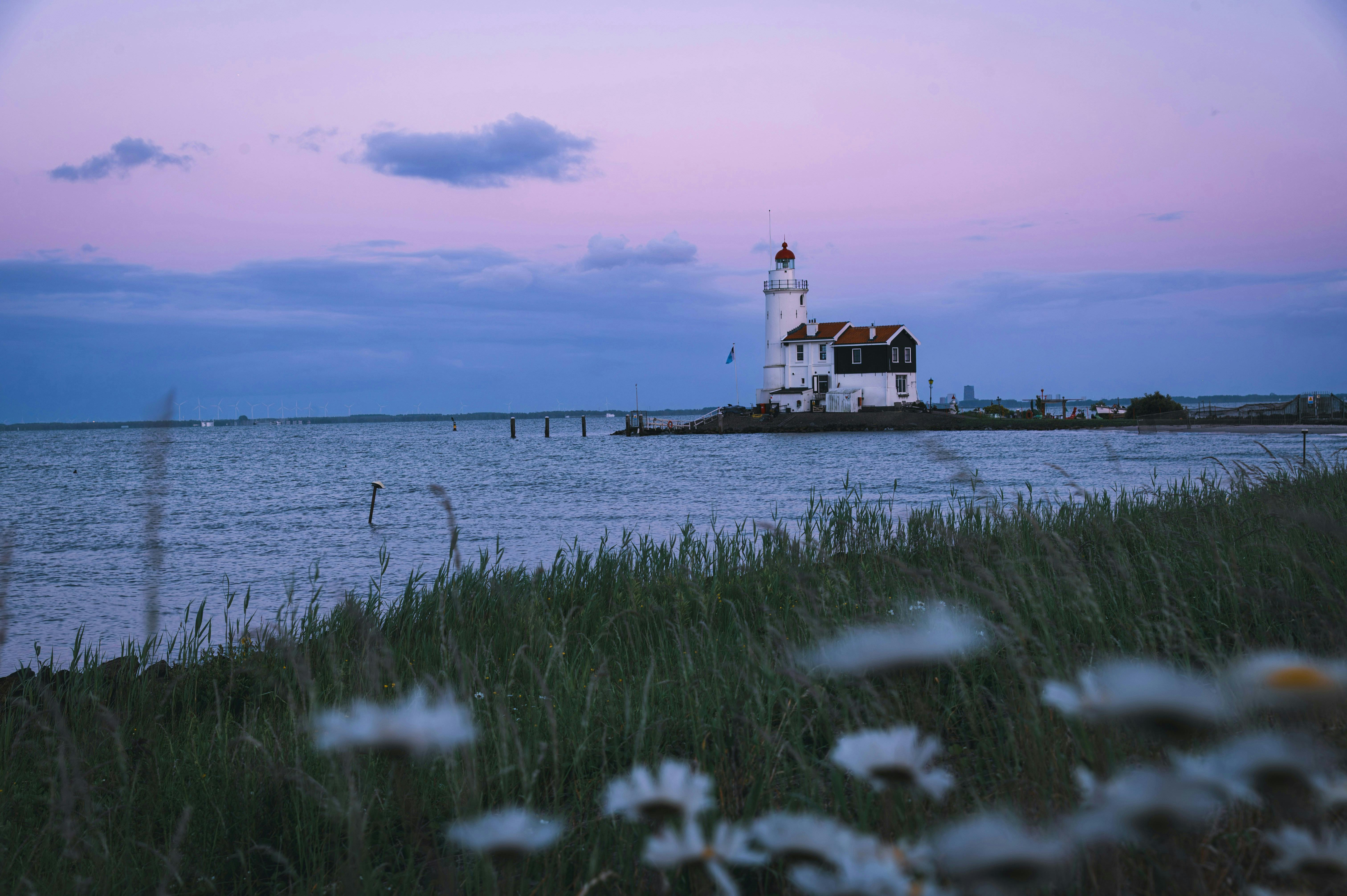 Serene view of a lighthouse during blue hour in Marken, Netherlands.