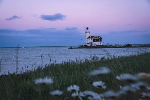 Serene view of a lighthouse during blue hour in Marken, Netherlands.