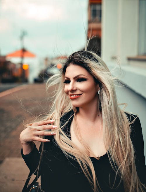 Free Woman Smiling While Wearing Black Top Stock Photo