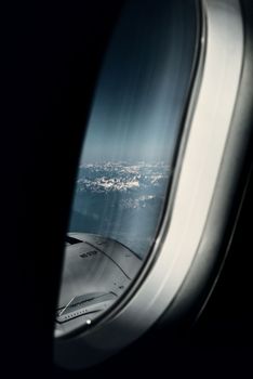 A breathtaking view of snow-capped mountains from an airplane window during flight.