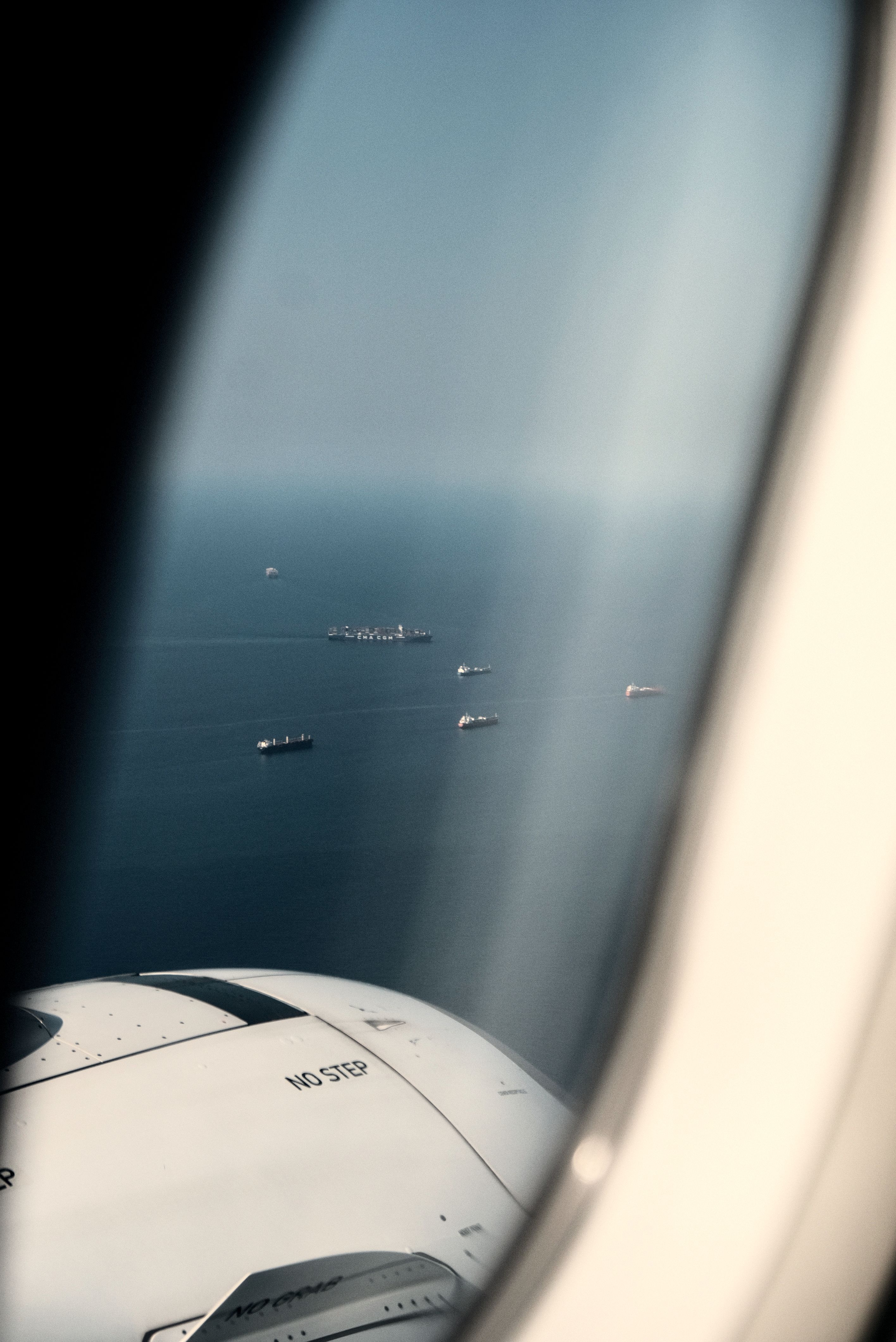 Oil tanker navigating a narrow strait with a cargo ship in the background