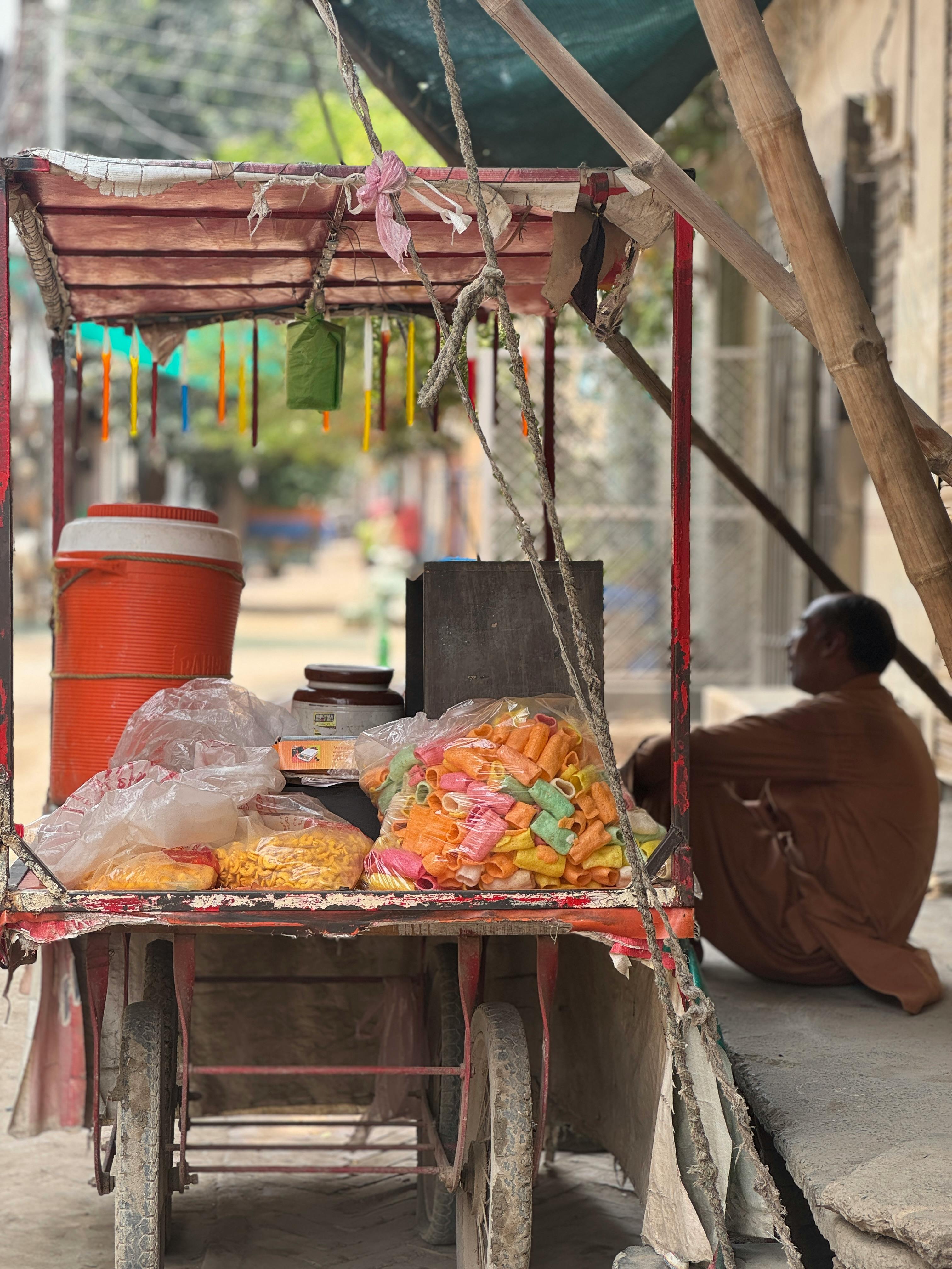 Traditional street food vendor cart in Burewala, Punjab, Pakistan showcasing colorful snacks.