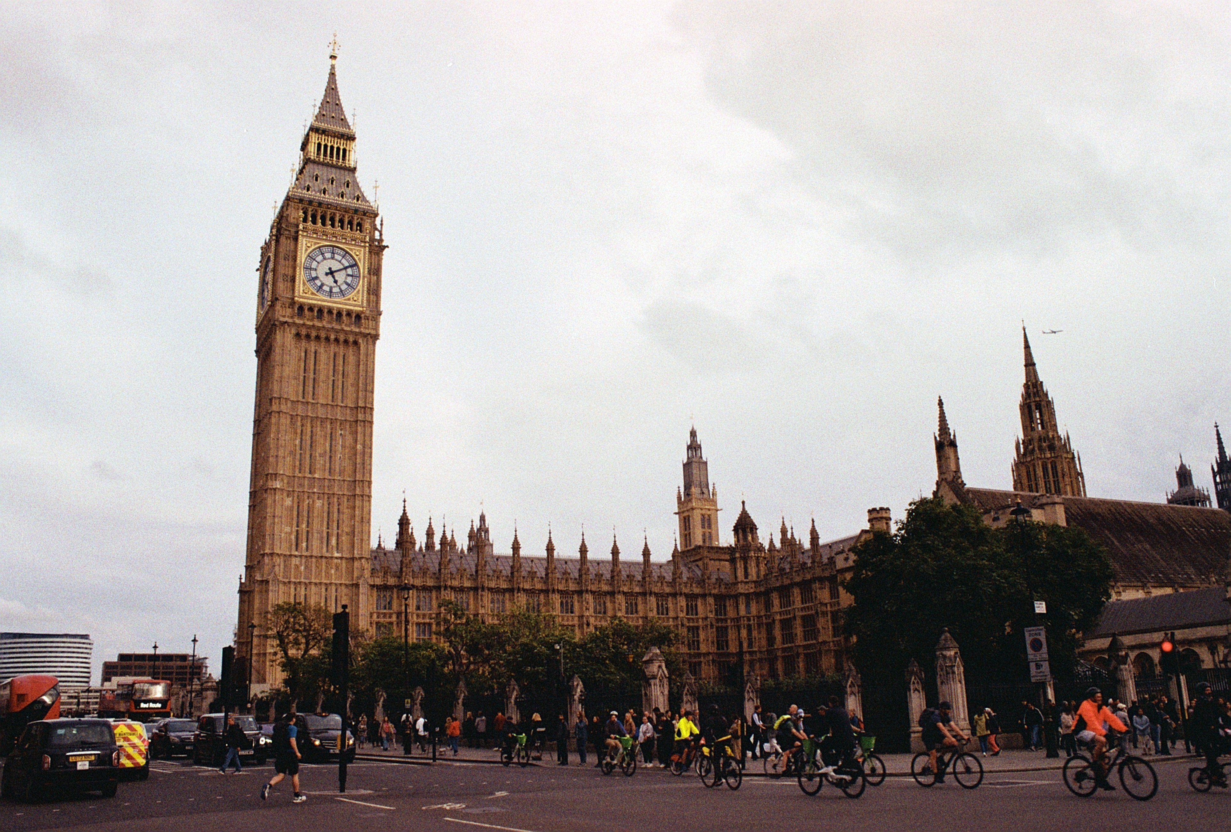 Big Ben and Westminster Palace with busy street scene, London landmark.