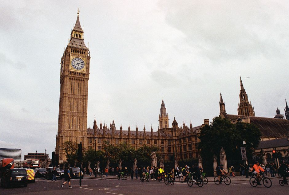 Big Ben and Westminster Palace with busy street scene, London landmark.