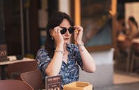 Chic Woman in Sunglasses at Milan Cafe