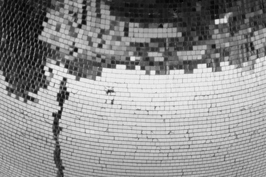 Abstract black and white image of a cracked disco ball showcasing intricate details and textures.