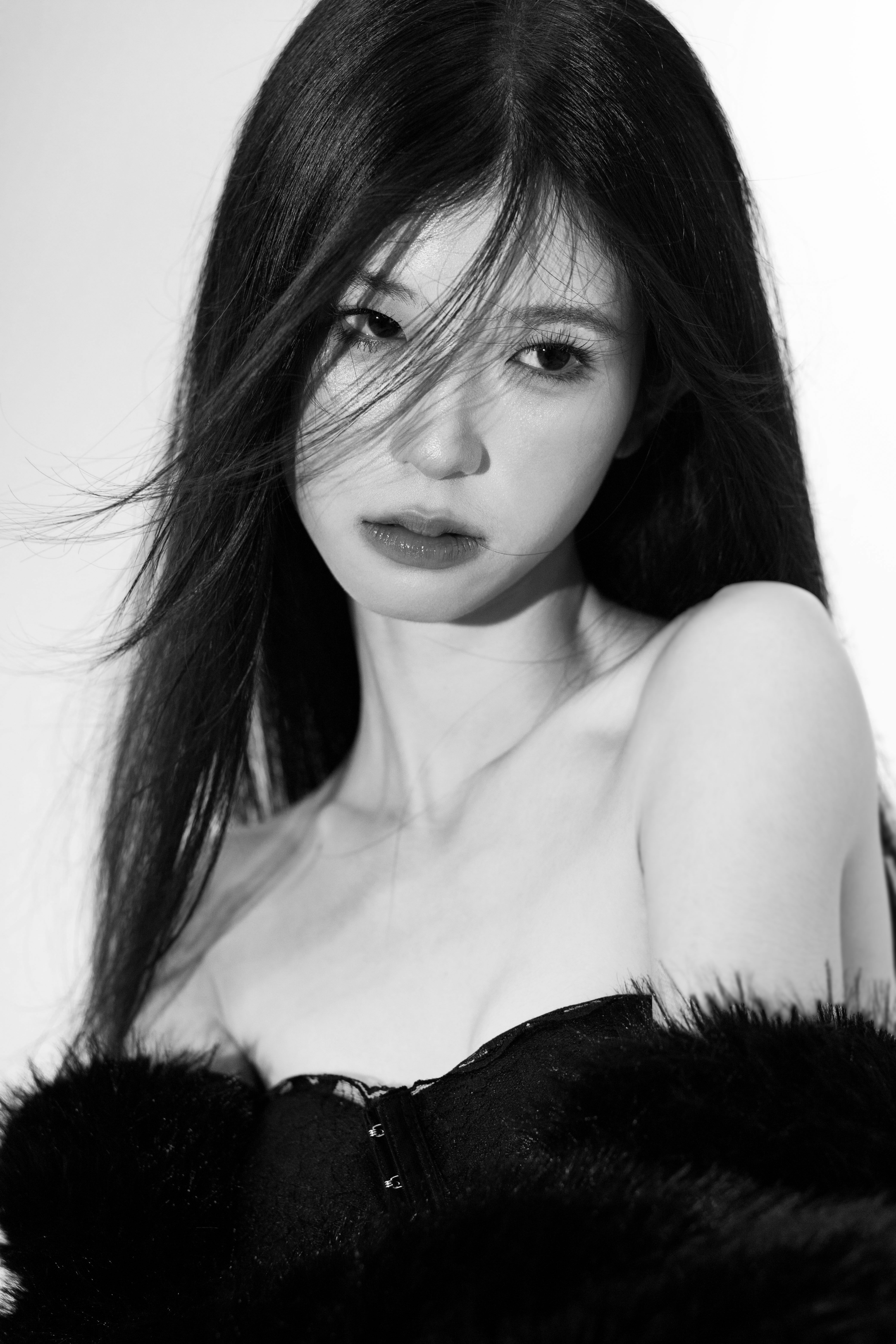 Black and white portrait of a woman with long hair, showcasing elegance and emotion.