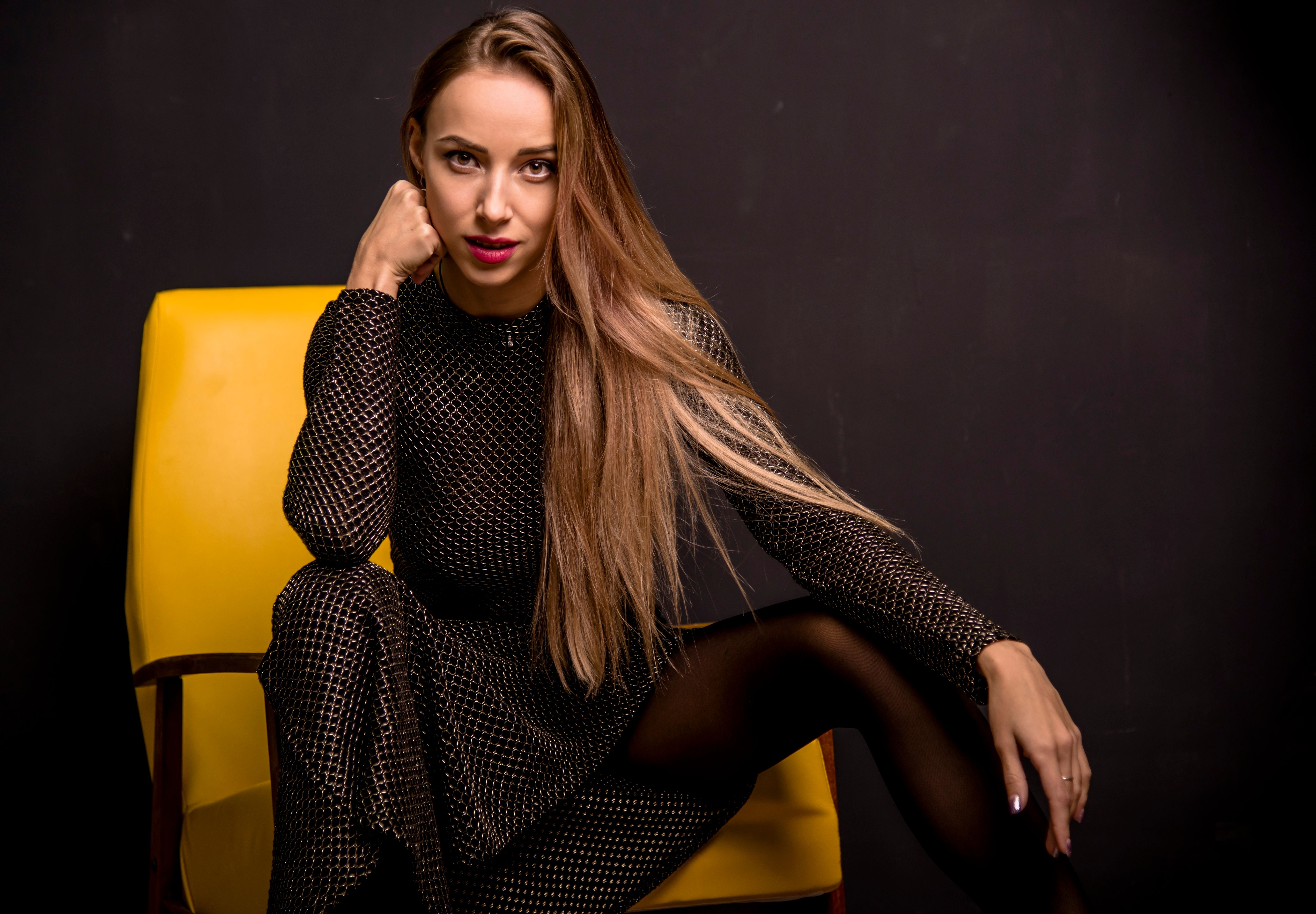 Elegant Woman Seated in Stylish Black Dress · Free Stock Photo