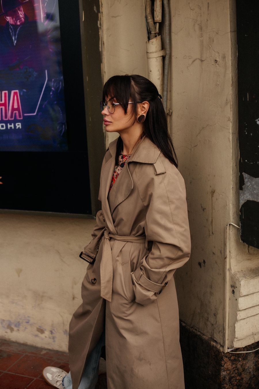 Model in a sand gradient long coat on stone steps — photo by IULIIA TIUNOVA on Pexels
