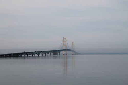 Free A tranquil shot of the iconic Mackinac Bridge enveloped in a misty atmosphere. Stock Photo