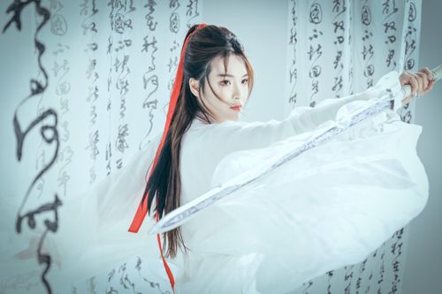 Free Graceful woman in traditional attire with sword, expressing strength and elegance. Stock Photo