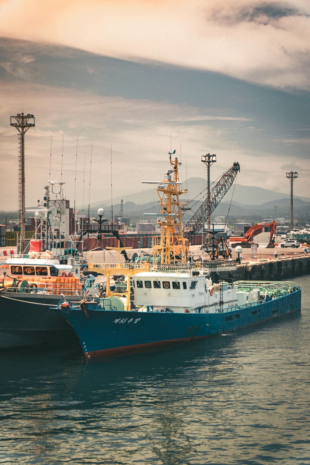 Colorful Fishing Boats Docked at Jeju Harbor · Free Stock Photo