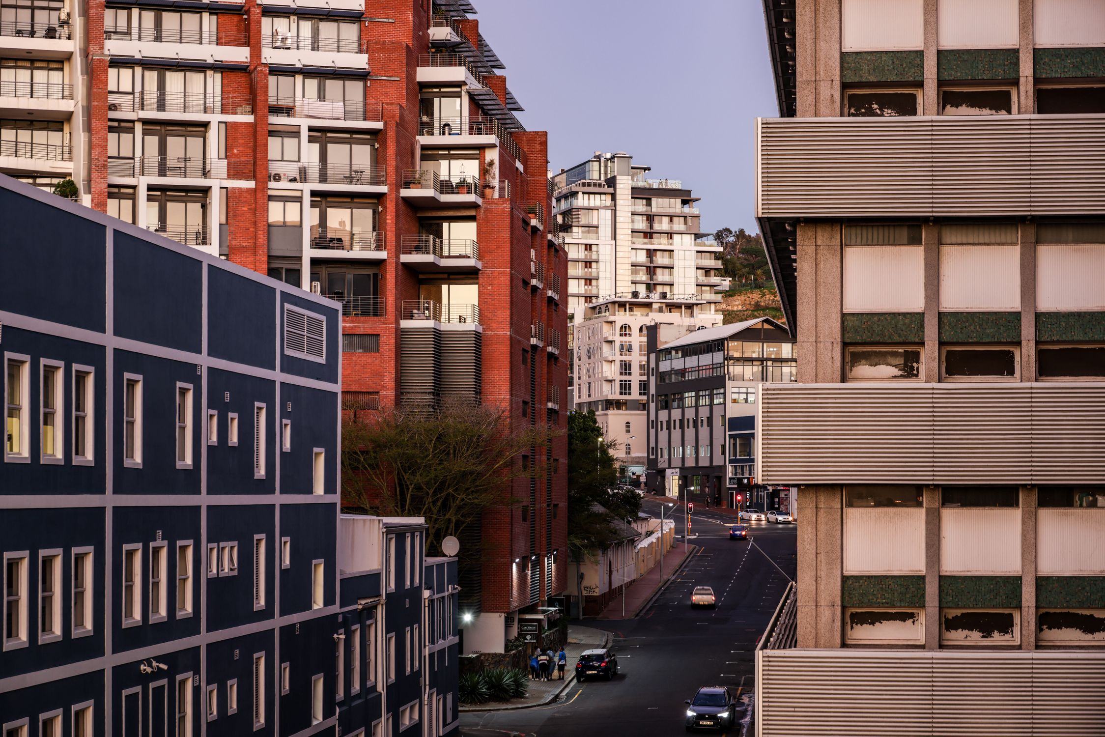 A quiet street scene in Cape Town showcasing diverse architecture at dusk