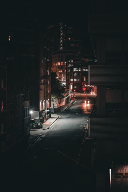 A dimly lit empty street captures the essence of a quiet city night.