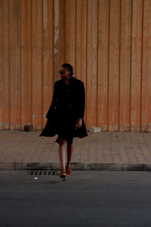 Stylish Woman Walking in Urban Setting · Free Stock Photo