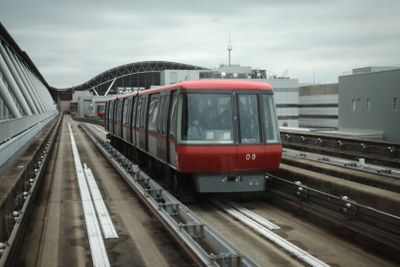 Airport express train arriving at an elevated platform, photo by Leongsan Tung on Pexels