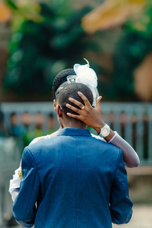 Free A touching moment as a couple embraces outdoors, capturing the essence of love and celebration. Stock Photo