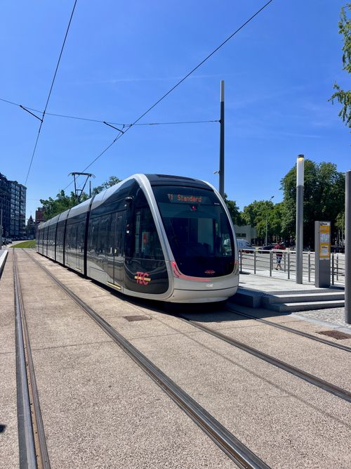 Free A sleek modern tram at an outdoor city station on a bright sunny day, showcasing urban transportation. Stock Photo