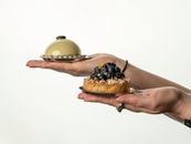 Tantalizing display of French pastries elegantly held against a white backdrop.