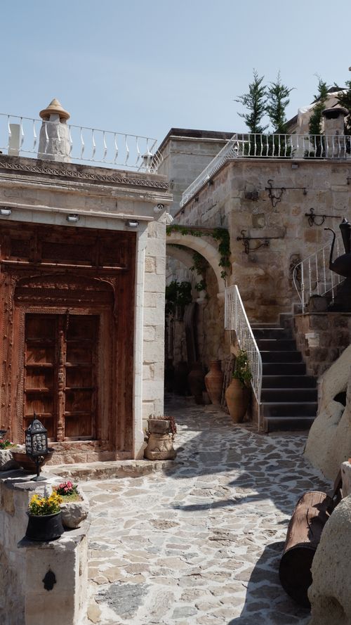 Free Rustic stone courtyard with traditional architecture on a sunny day. Stock Photo