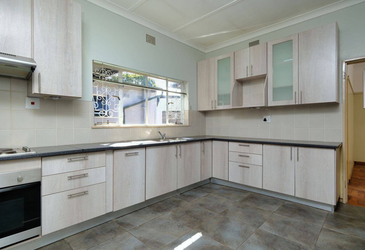 Kitchen Spraying in Crews Hill — clean edges cut in around trim and sockets
