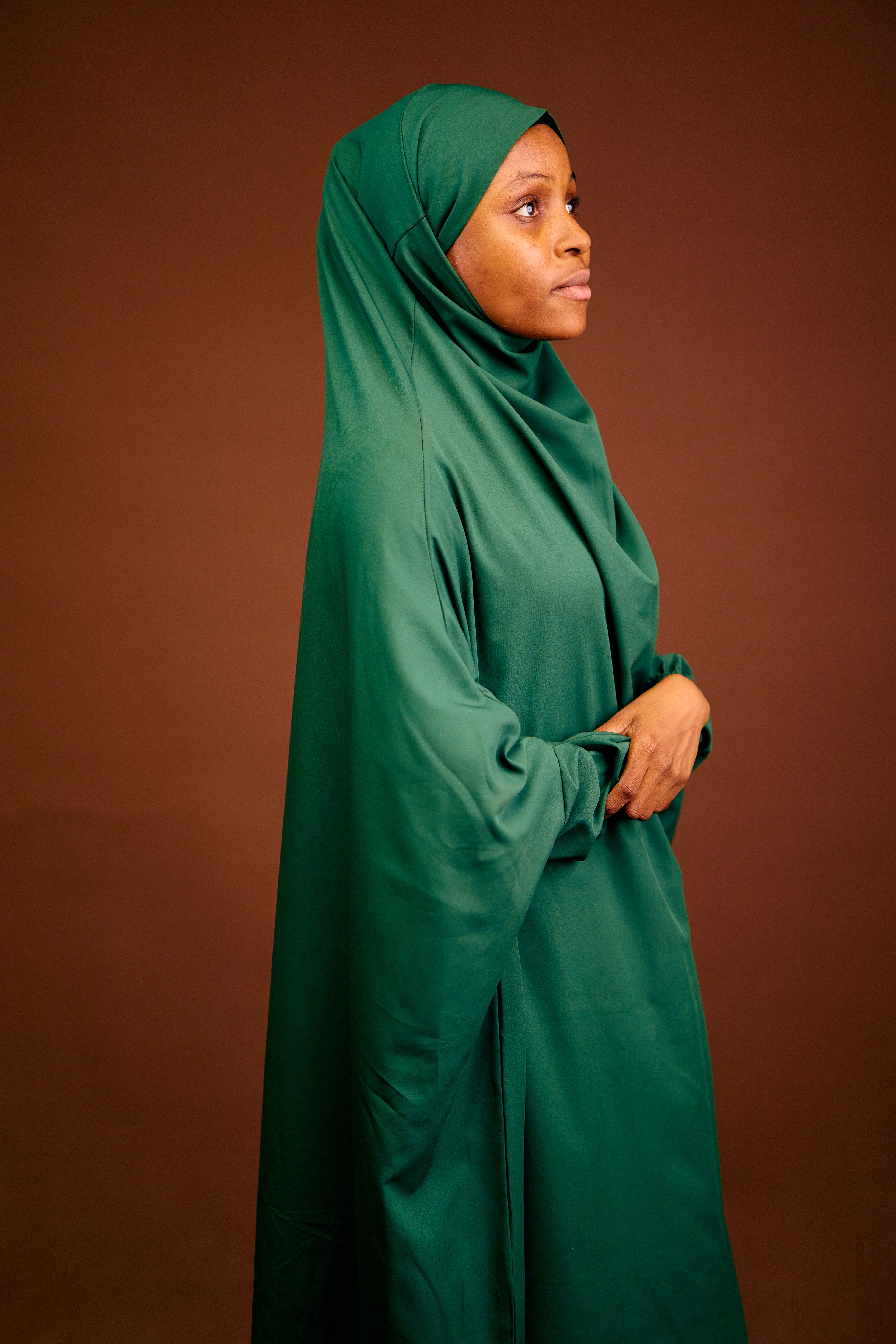 Portrait of Woman in Green Hijab on Brown Background · Free Stock Photo