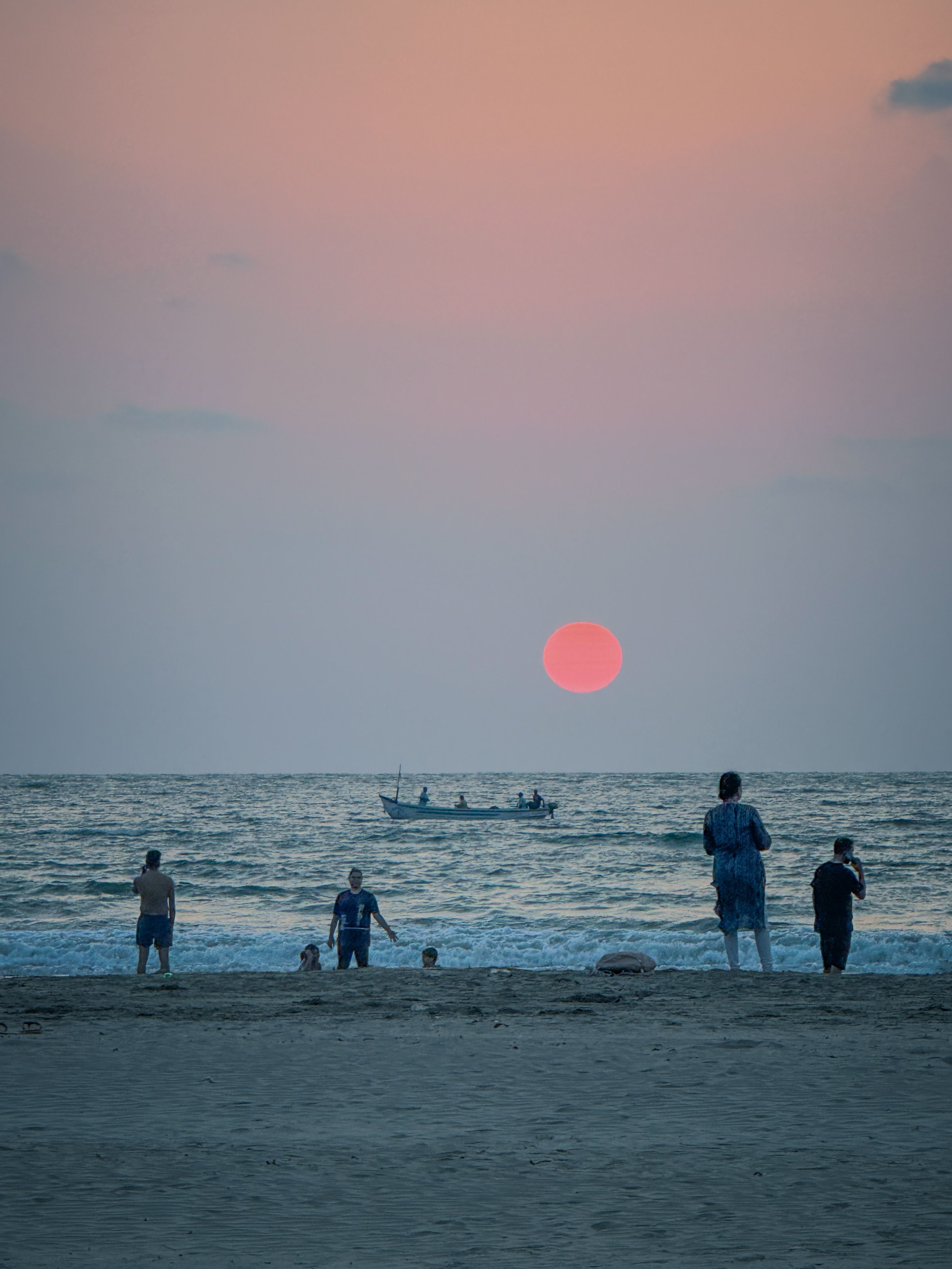Serene Beach Sunset with People Silhouettes · Free Stock Photo