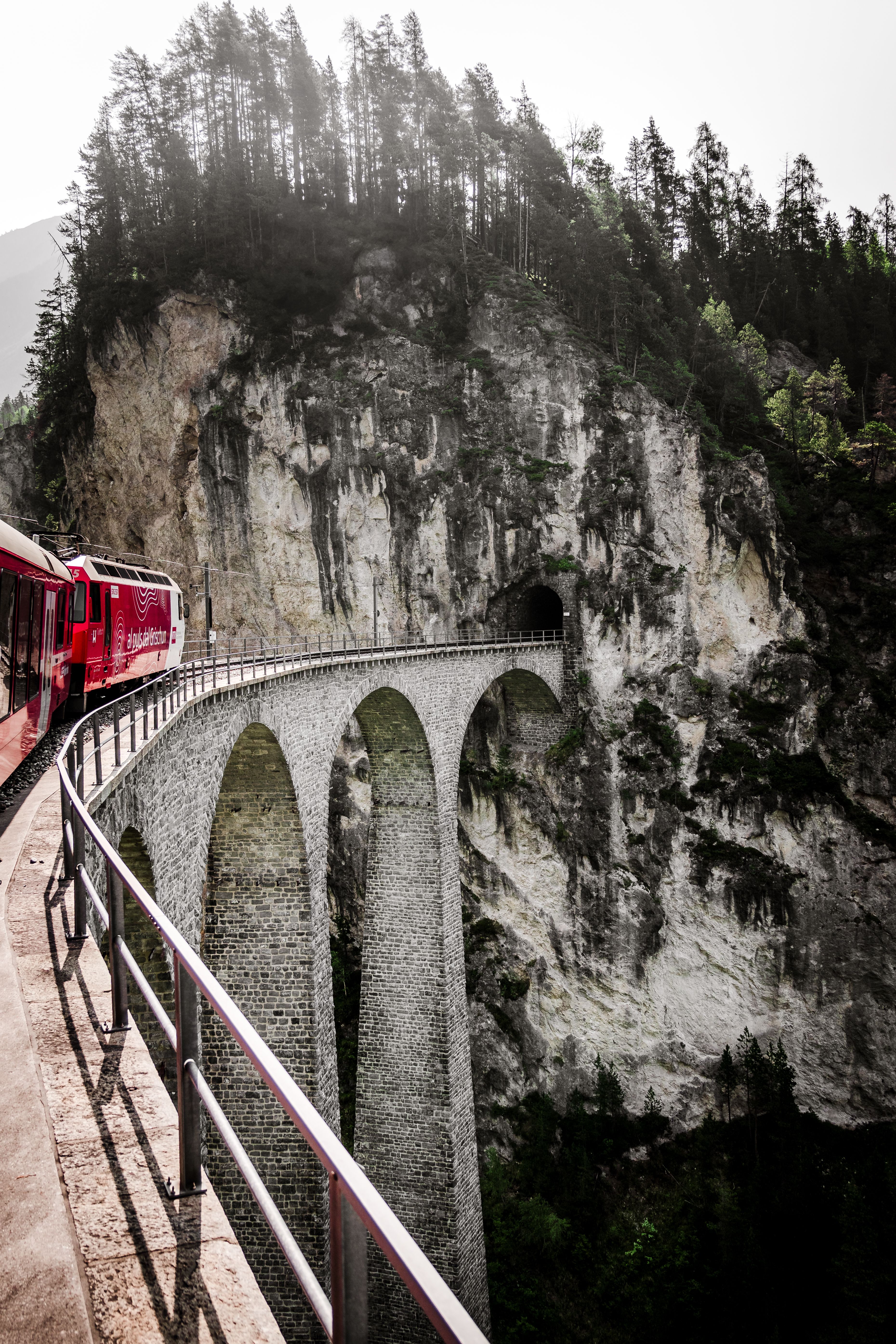 Red Train on a Bridge with Scenic Mountains in the Background · Free ...
