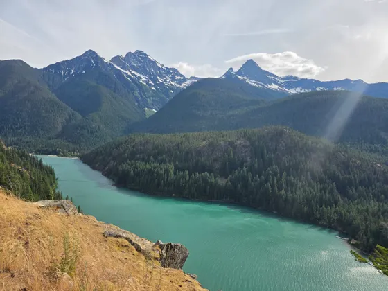 Turquoise Ross Lake stretching north between forested ridges