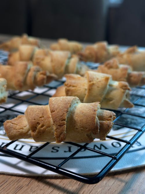 Free Golden croissants cooling on a wire rack, evoking fresh bakery vibes. Stock Photo
