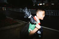 Smiling Child Walking at Night With Umbrella