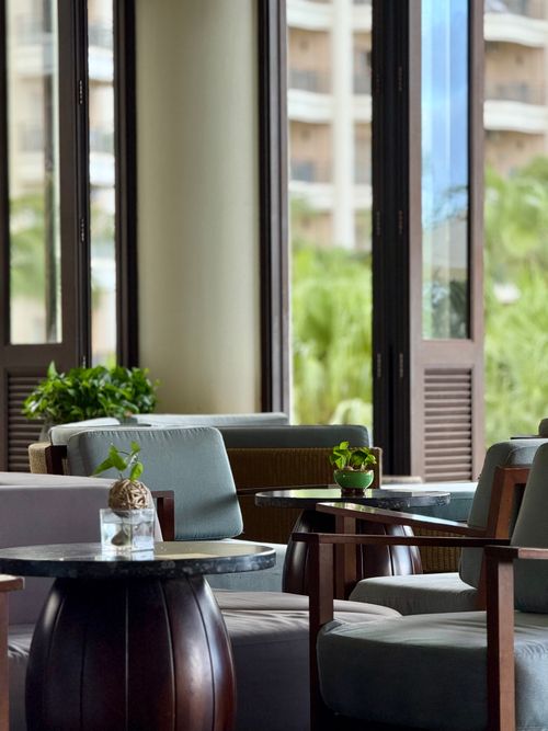 Free A serene lounge setting with elegant seating and lush outdoor view. Stock Photo