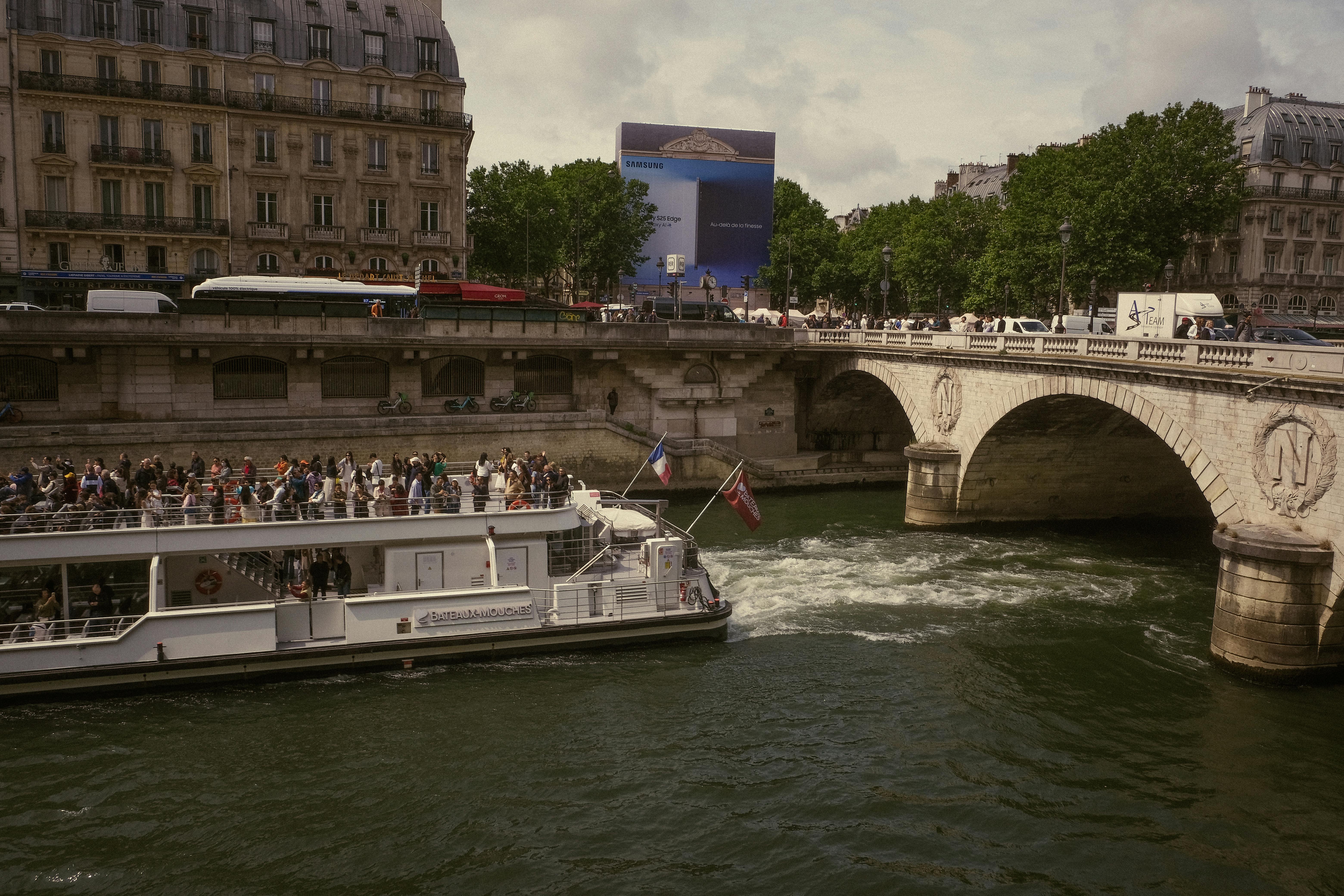 Cruise boat under a Paris bridge