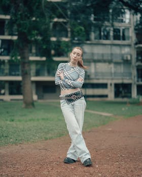 Casually dressed woman poses confidently in urban park setting of Buenos Aires, Argentina.