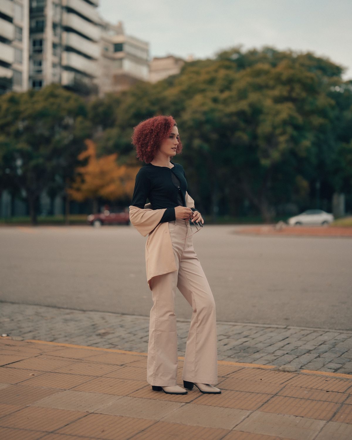 Latina woman in an embroidered off-the-shoulder blouse paired with jeans