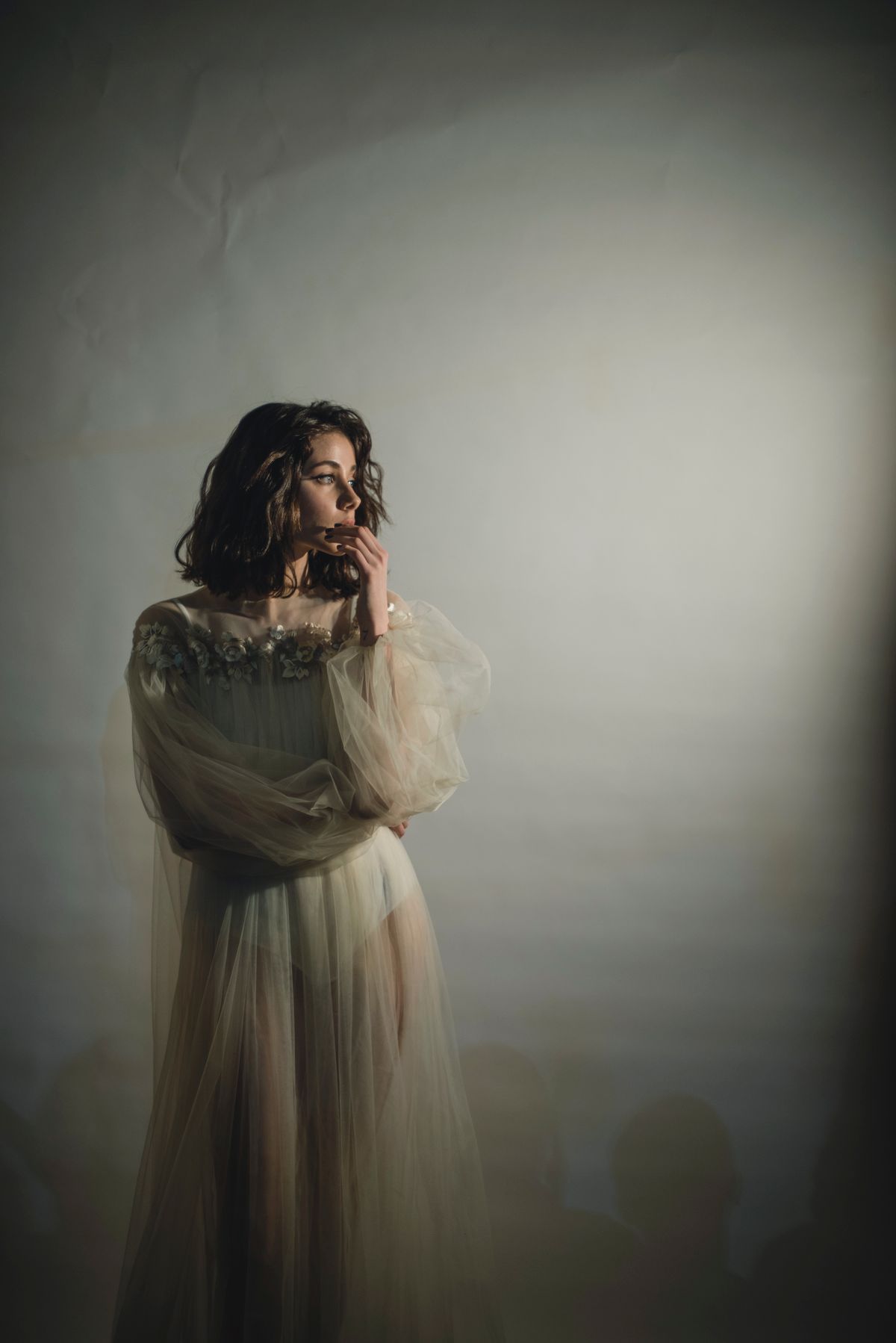A woman in a delicate white chiffon dress