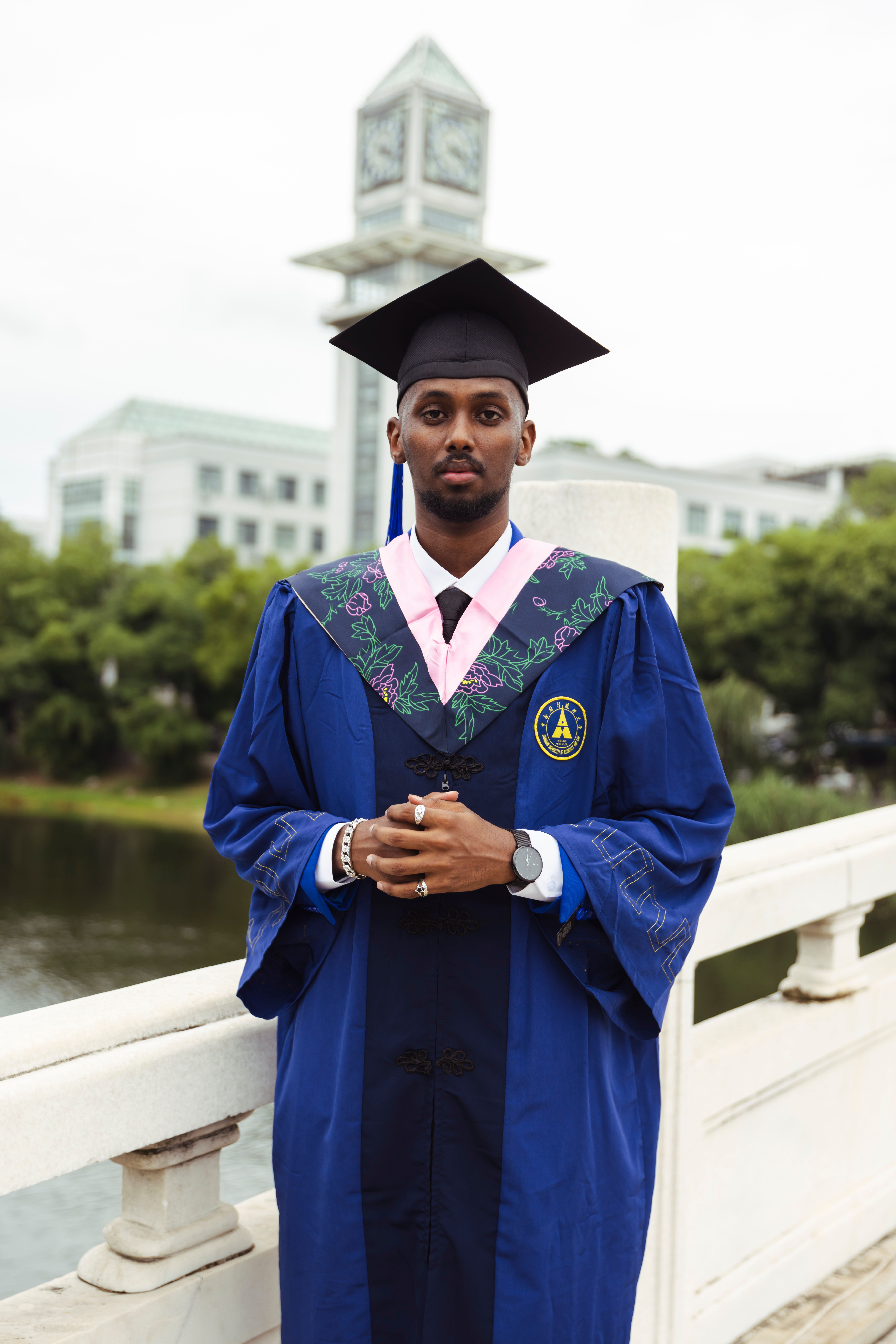 Male Graduate in Cap and Gown Posing Outdoors · Free Stock Photo